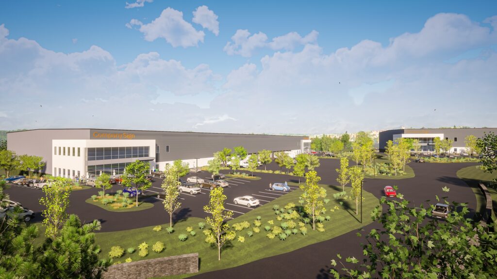 A large industrial complex with gray buildings, parking lots, and landscaped green areas under a blue sky with clouds. Several cars are parked, and trees are scattered throughout the property.